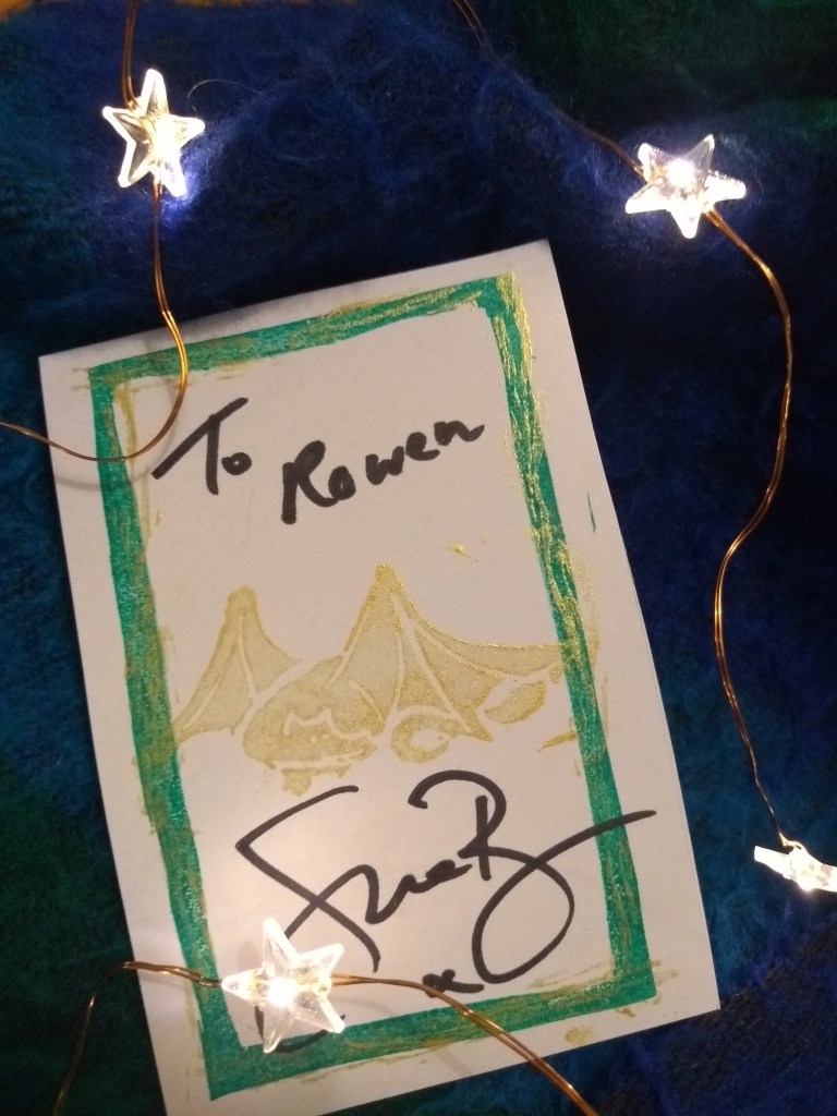 A bookplate signed To Rowen, printed with a golden dragon, green 